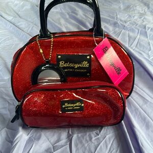 Brand new betsy bag with the tags never used . Comes with the keychain mirror